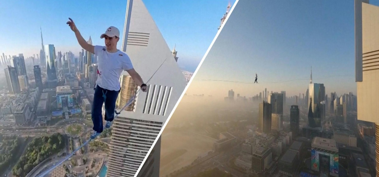 Koorddanser wandelt tussen twee wolkenkrabbers in Dubai