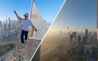 Koorddanser wandelt tussen twee wolkenkrabbers in Dubai