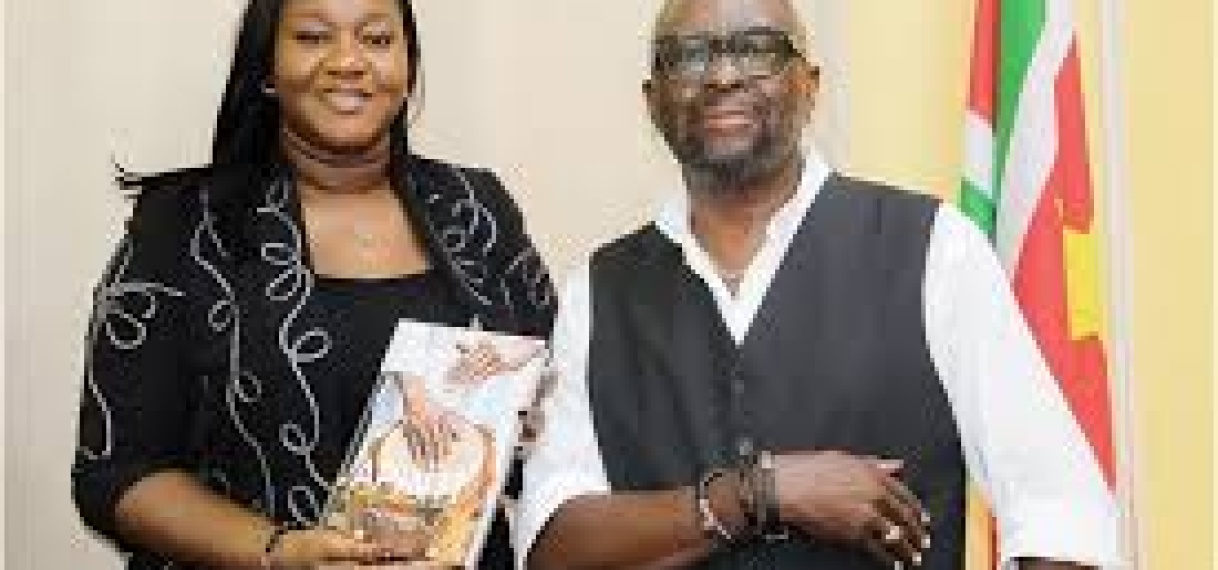 André Mosis overhandigt boek over Apinti-drum aan minister Huur